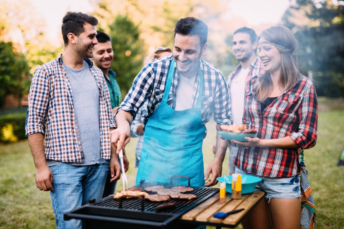 Young people grilling outdoors